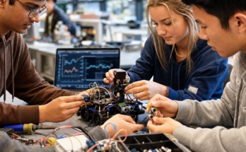 Students and makers assembling a physical AI robot prototype with sensors and edge hardware