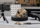 Generic smartphone capture setup beside a handheld 3D scanner and mechanical part