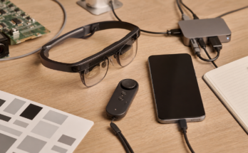 Developer workbench with lightweight XR glasses, phone, controller, and calibration notes