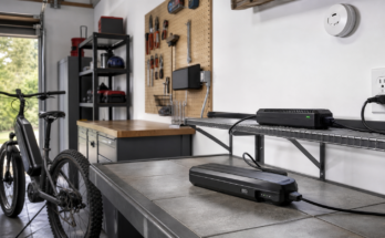 Garage e-bike charging zone with clear space and battery on a nonflammable surface