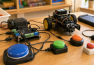 Accessible STEM control station with large switches, microcontroller board, and small robot