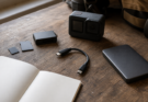 Field media logging kit with memory cards, reader and action camera on a workbench