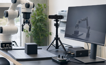 Robotics simulation workstation with robot arm, depth-camera rig and neutral rendered test scene