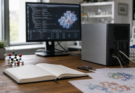 A scientific AI workstation with lab notes, molecule models and a compact compute stack.