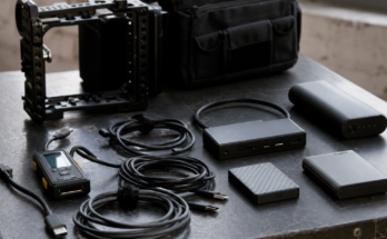  unbranded USB-C cables, portable SSDs, dock, camera cage, cable tester and battery pack, natural daylight, no logos, no read