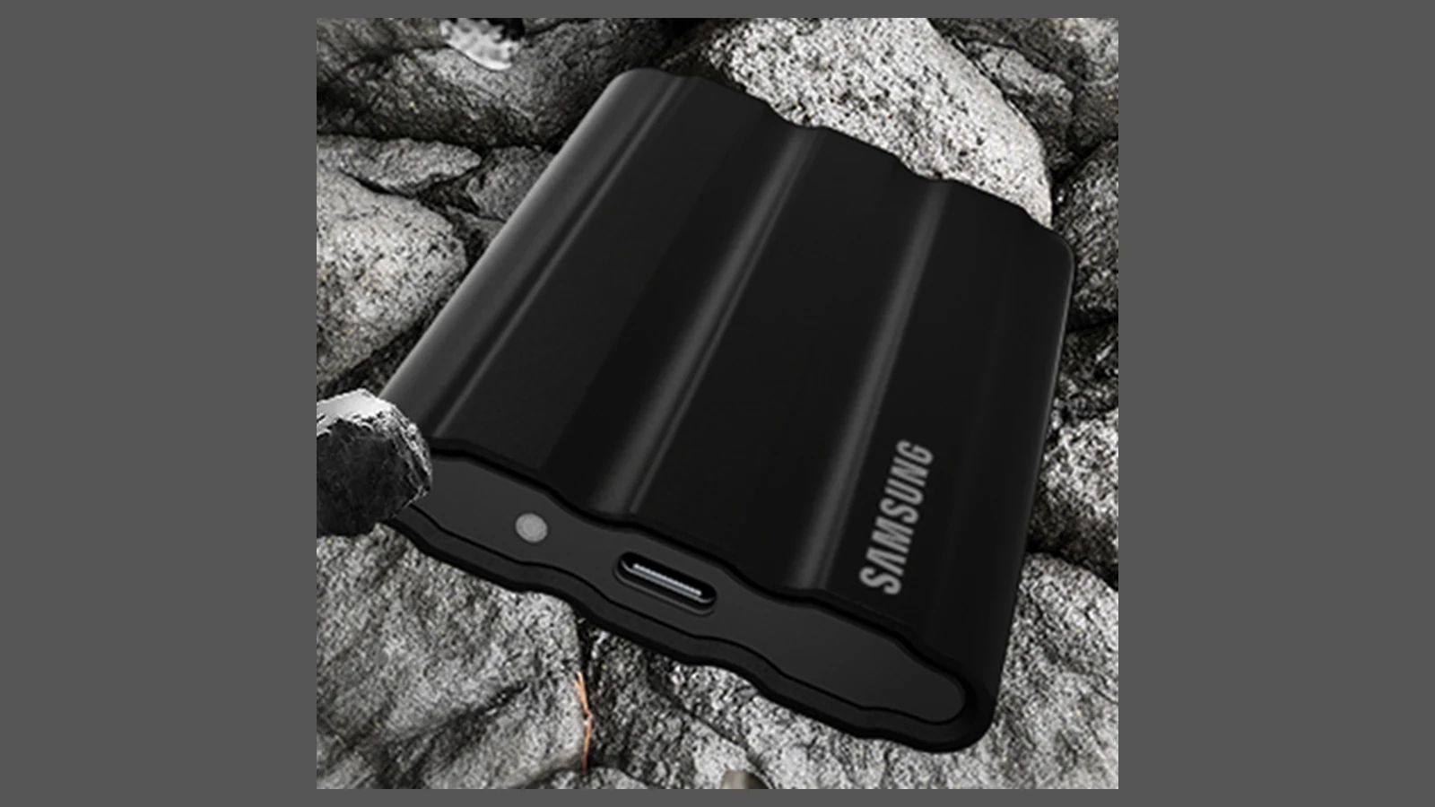 Samsung T7 Shield portable SSD among rocks