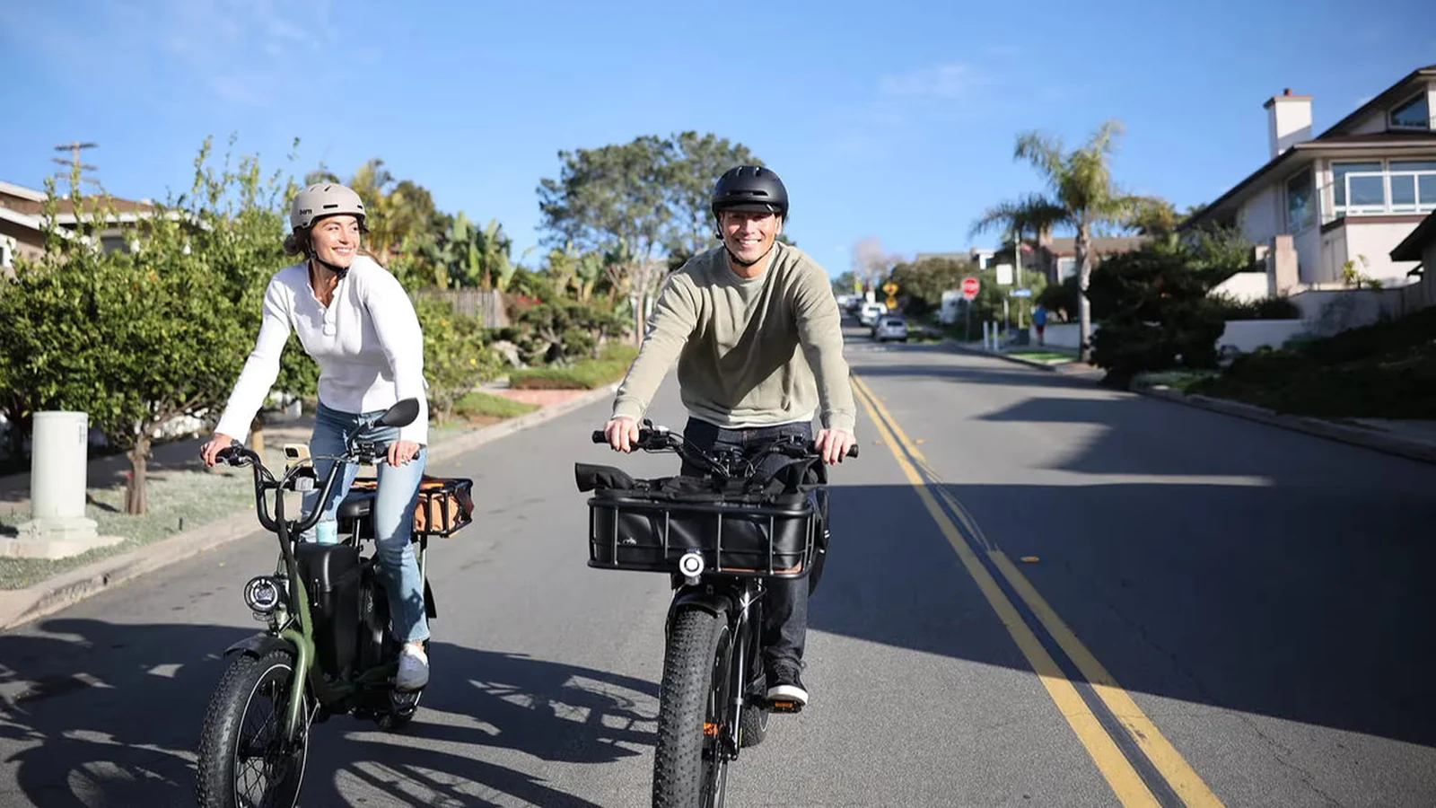 Two riders using utility-style electric bicycles