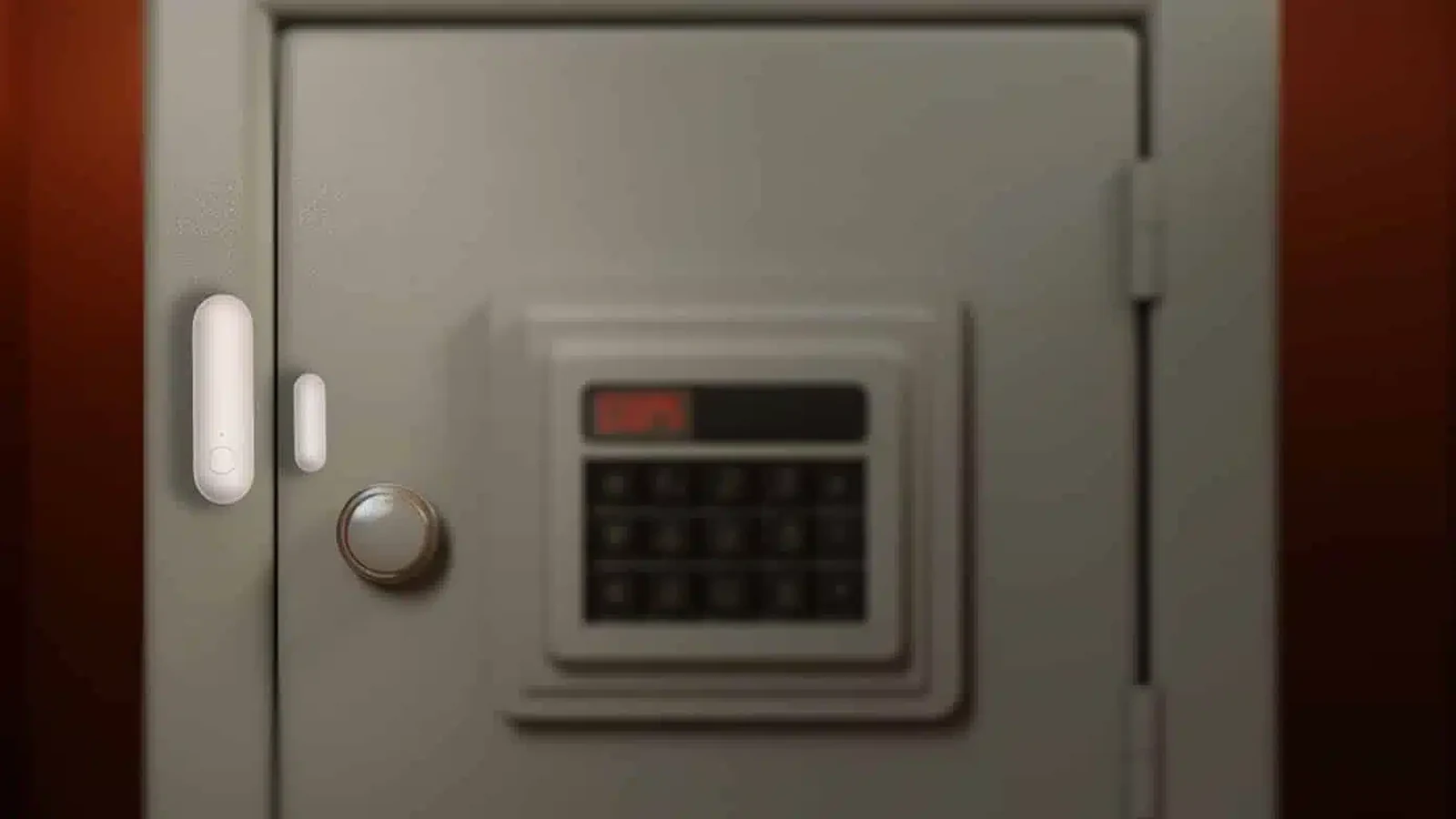 Door contact sensor installed across the seam of a metal safe