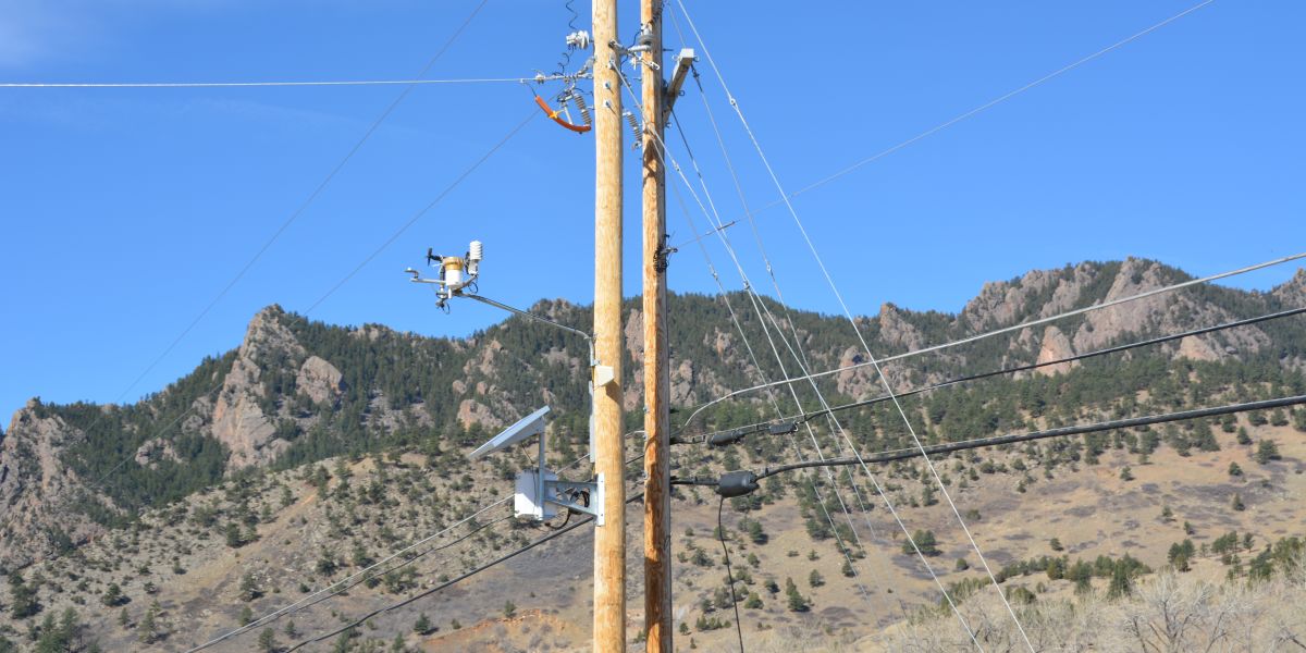 Pole-mounted Campbell Scientific field monitoring instruments in a mountain deployment