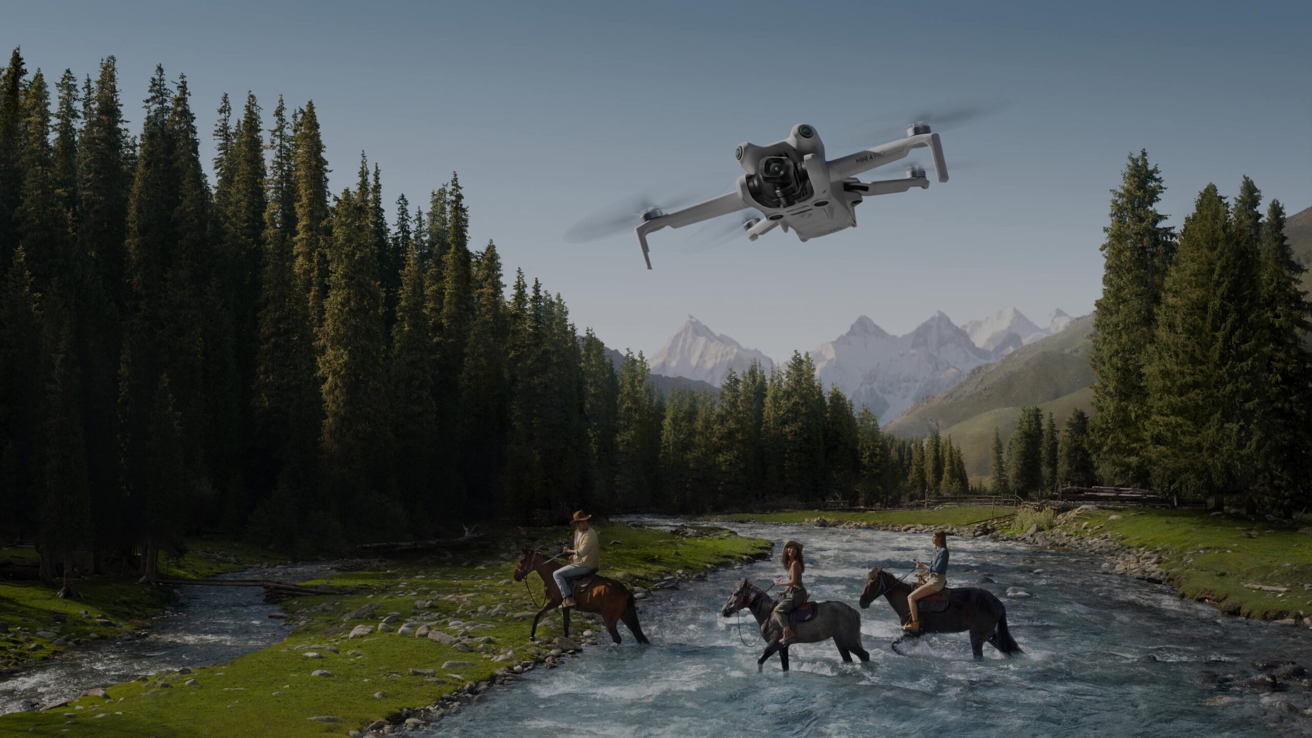 DJI Mini 4 Pro recording riders crossing a mountain river