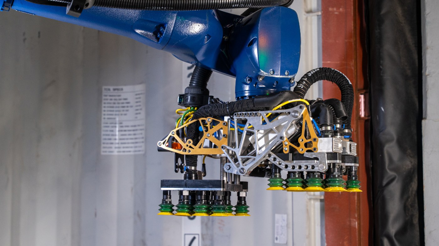 Close-up of KUKA Contoro robot gripper handling warehouse cartons