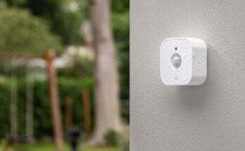 Real smart home motion sensor mounted on an exterior wall for Matter and Thread placement planning
