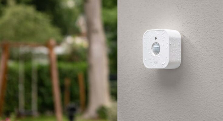 Real smart home motion sensor mounted on an exterior wall for Matter and Thread placement planning