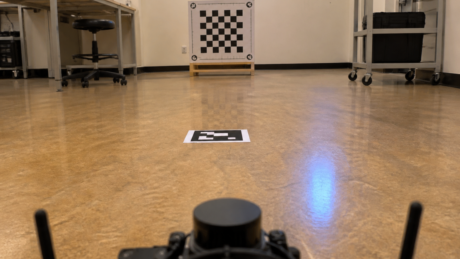 Low-angle robot camera view toward calibration target and floor markers