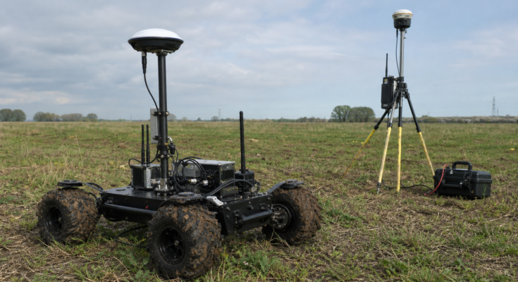 Small field robot RTK correction test with GNSS antenna, radio module, LTE modem, and base station tripod
