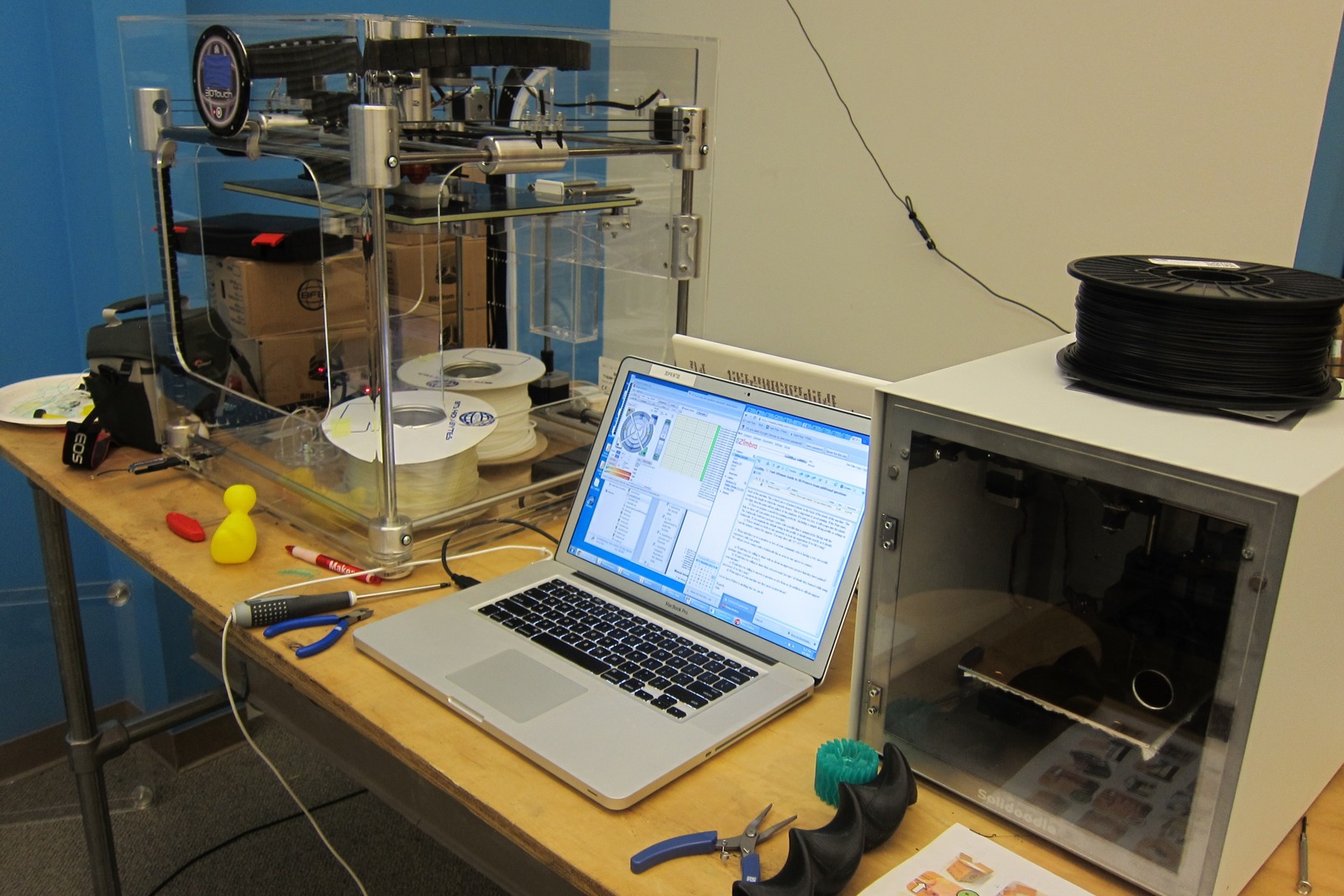 Open-frame FDM printers and motion hardware in a workshop