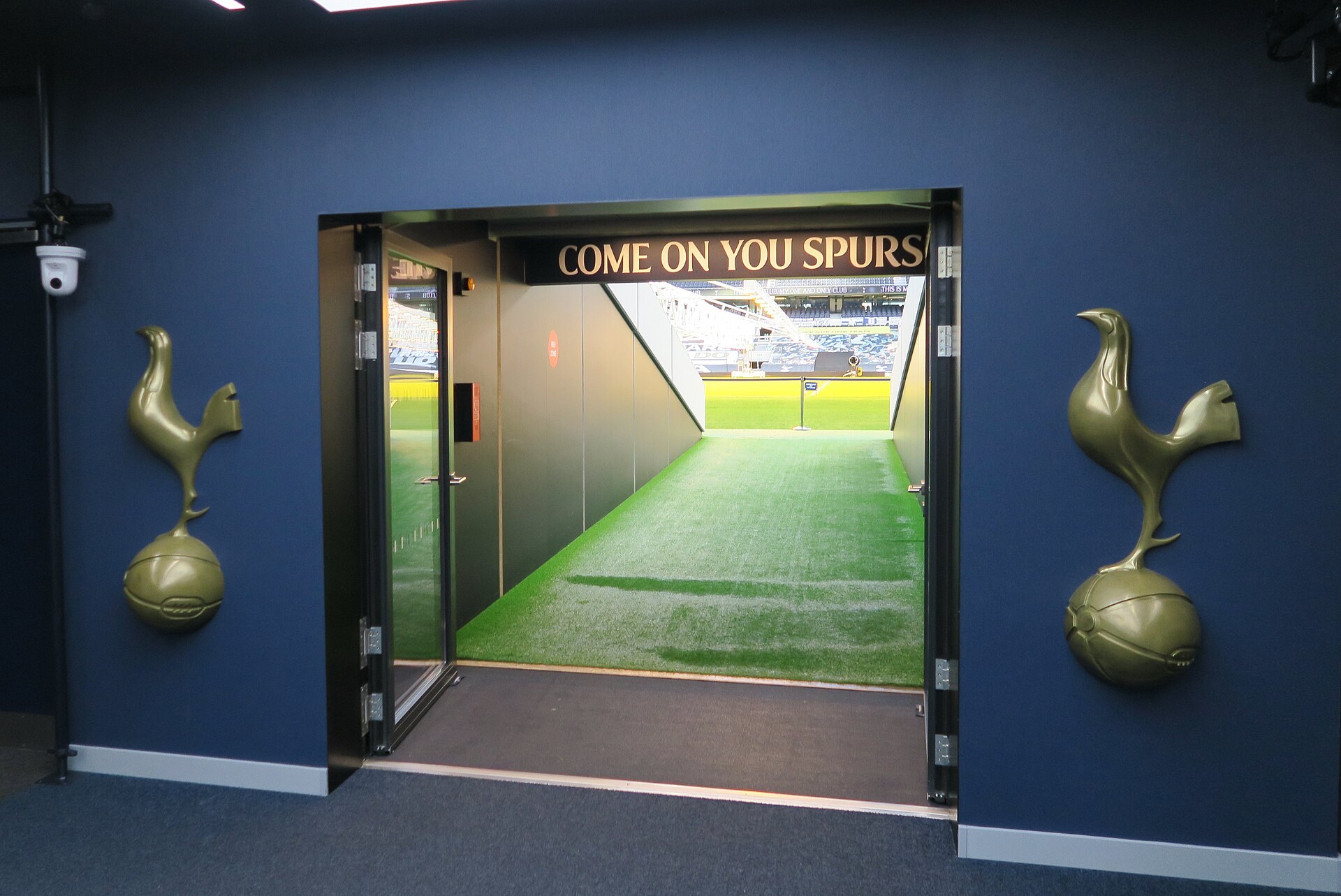 Players tunnel leading toward the pitch at Tottenham Hotspur Stadium.