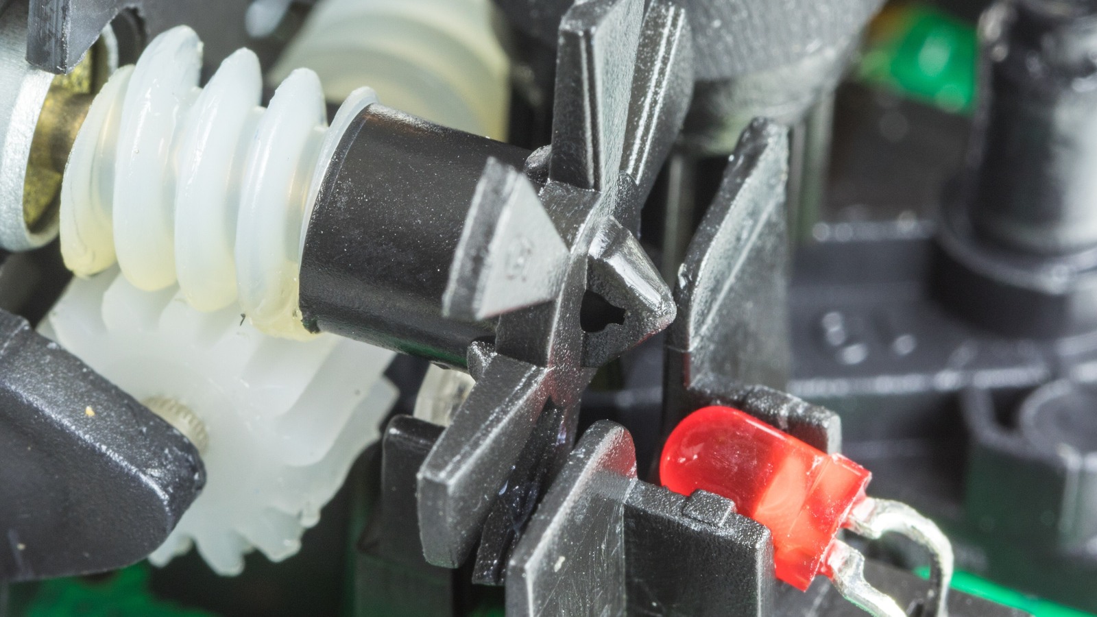 Incremental encoder mechanism with slotted wheel and photoelectric sensor.