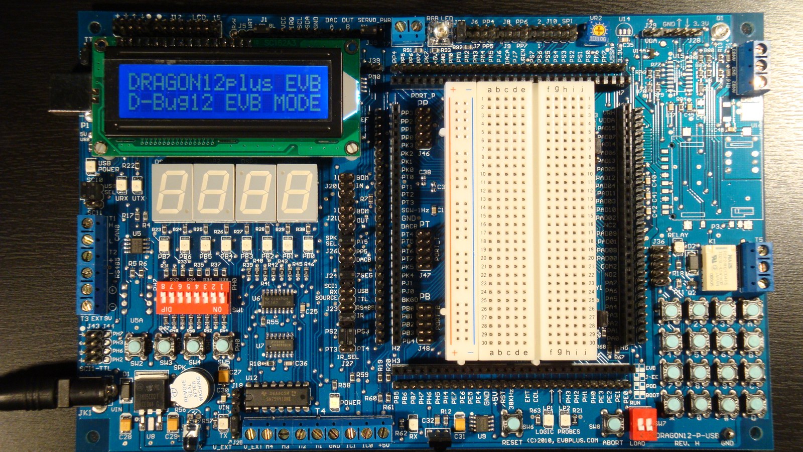 Microcontroller evaluation board on an electronics bench Microcontroller evaluation board on an electronics bench