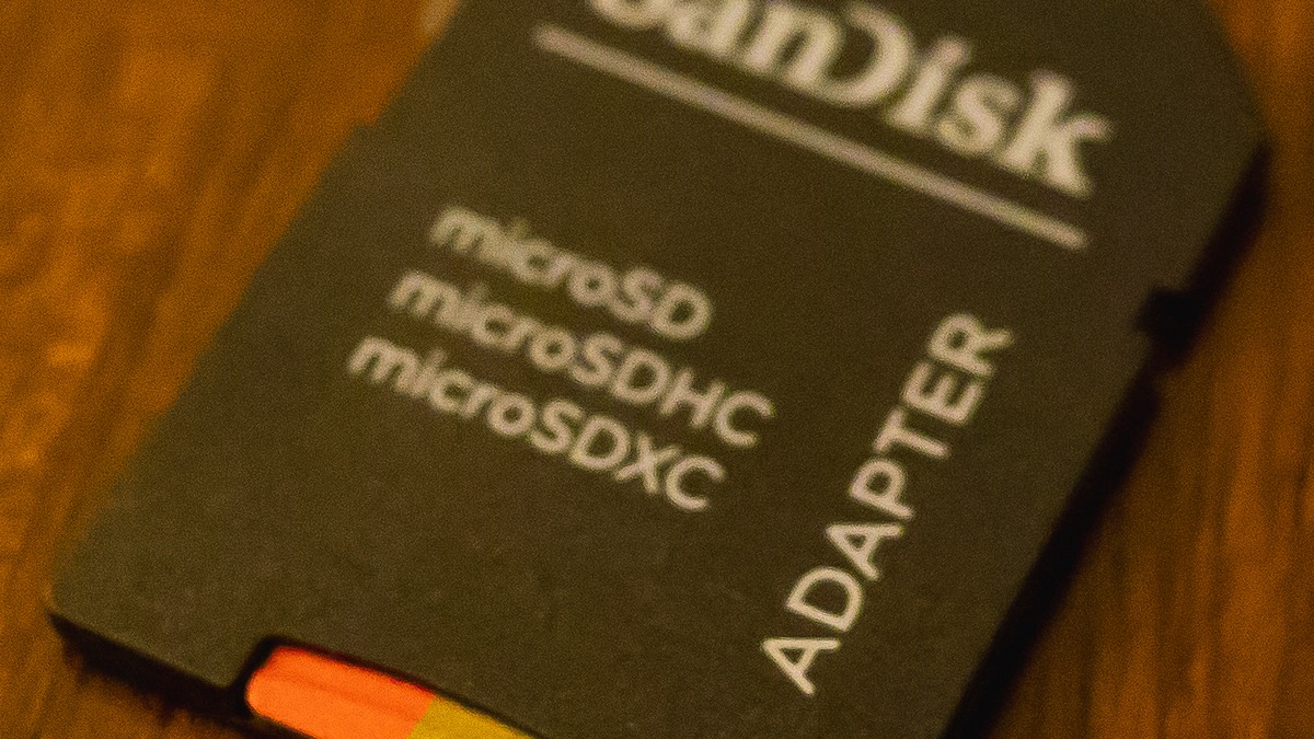 microSD card adapter on a wooden surface