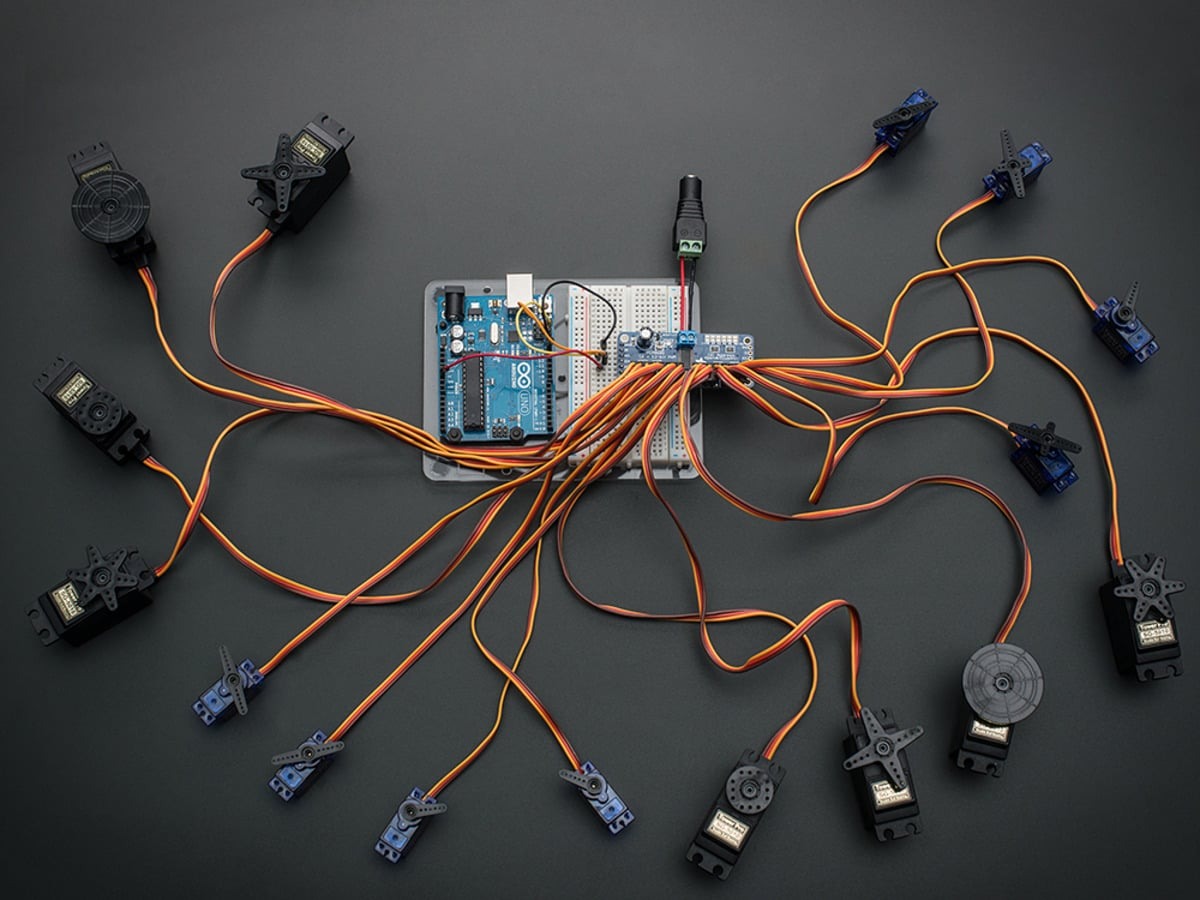PCA9685 board connected to an Arduino and twelve servo motors