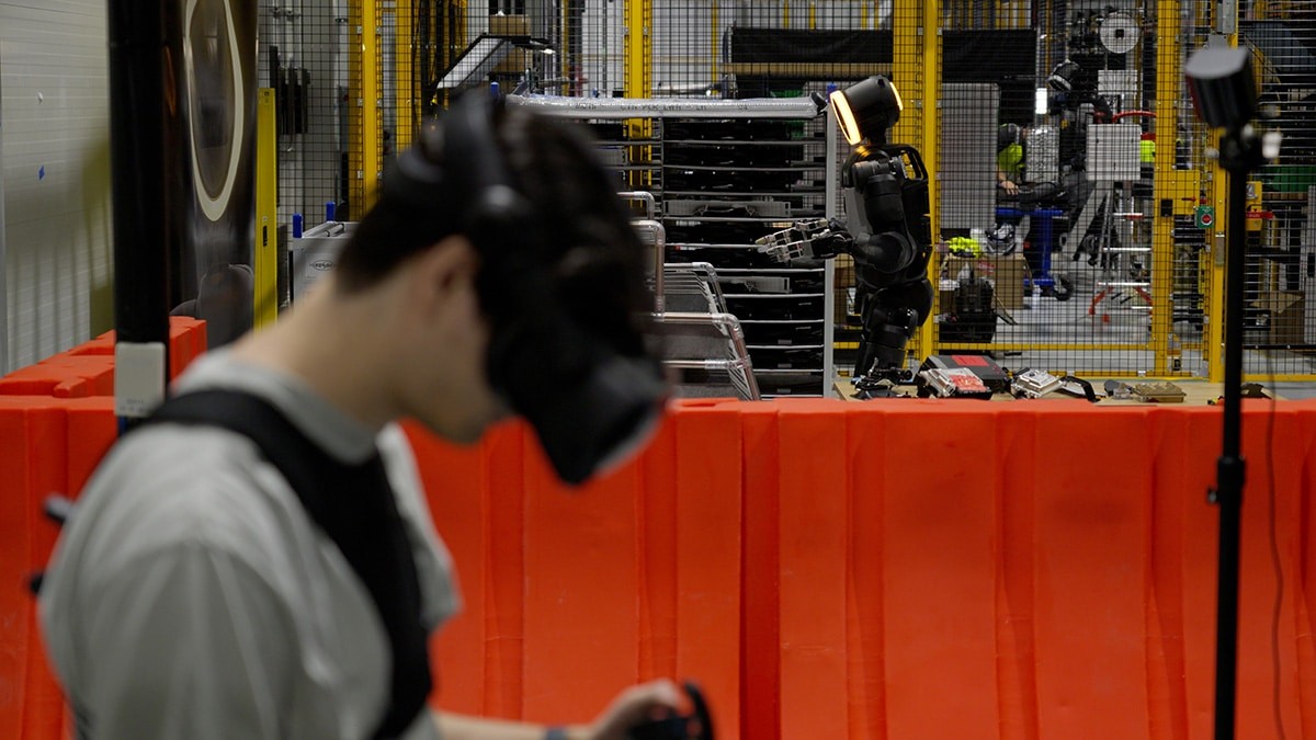 Atlas training behind a safety barrier while an operator uses a control device at RMAC