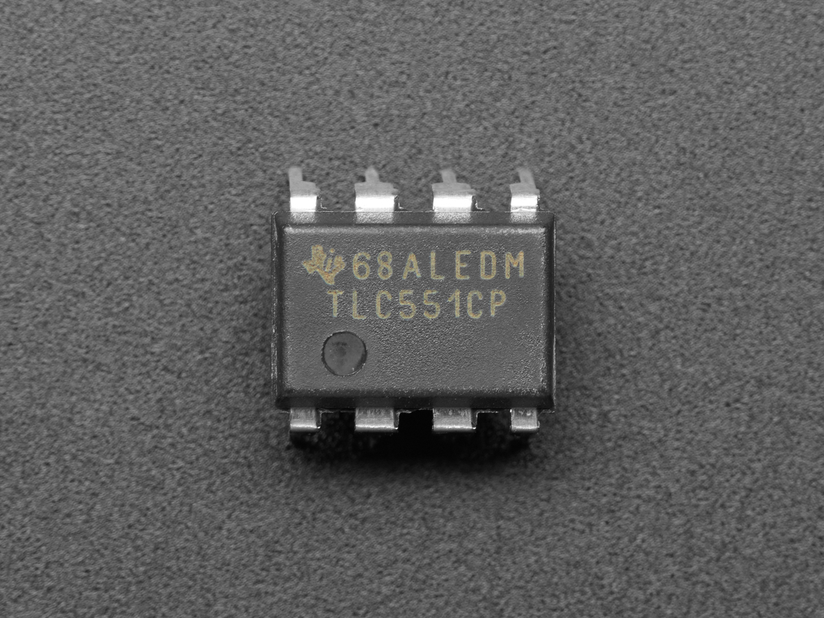 Top view of a TLC551CP timer IC showing its part marking