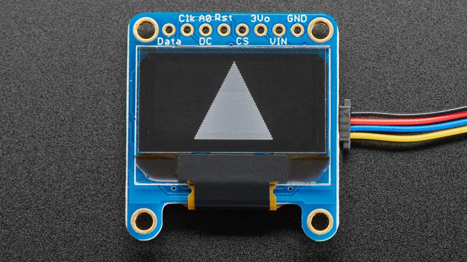 Adafruit SSD1306 OLED module displaying a white triangle graphic