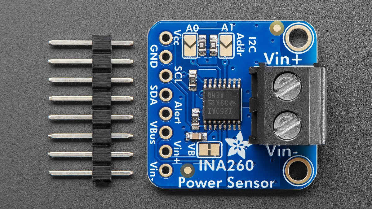 Front view of the INA260 breakout beside its loose header pins