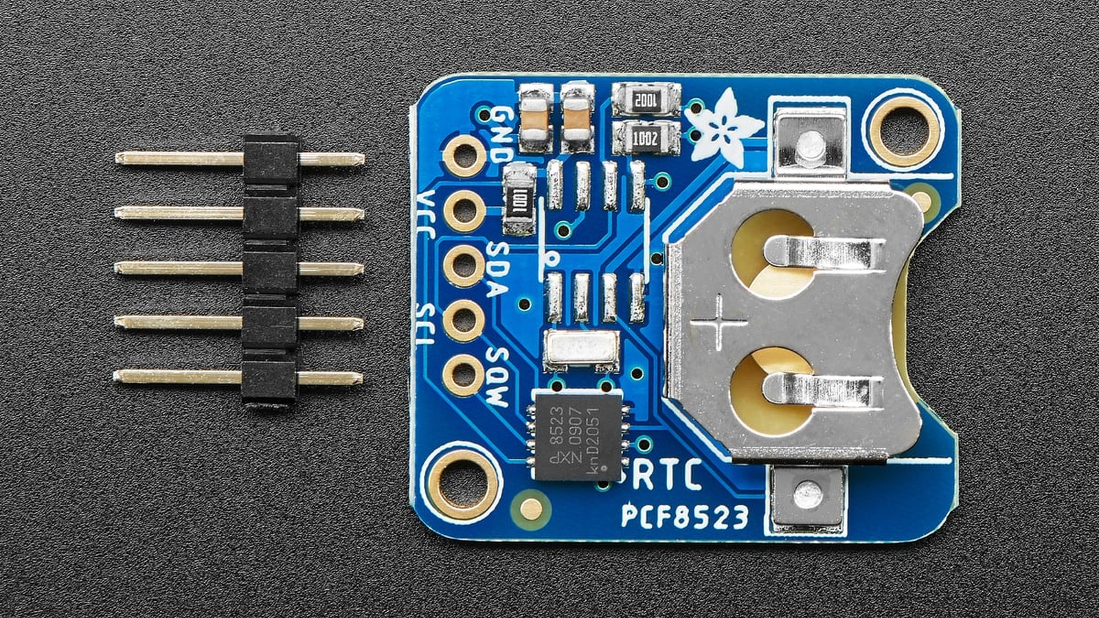 Angled view of the PCF8523 breakout showing the connector pins and battery holder